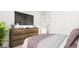 Bedroom featuring a wooden dresser with a TV, closet door and a potted plant at 905 Myers Point Dr, Morrisville, NC 27560