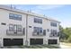 White townhomes with dark garage doors and balconies for each unit, showcasing modern design at 905 Myers Point Dr, Morrisville, NC 27560