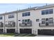 A view of the exterior facade of a white townhouse row, each with balconies and garage doors at 905 Myers Point Dr, Morrisville, NC 27560