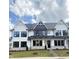 Charming white and gray townhouse featuring manicured lawn and modern architectural details at 905 Myers Point Dr, Morrisville, NC 27560
