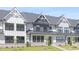 Charming townhouse row with white exteriors, stone accents, and neat landscaping at 905 Myers Point Dr, Morrisville, NC 27560