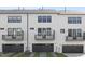 Exterior showcasing the garages and second-story balconies of this white townhome building at 905 Myers Point Dr, Morrisville, NC 27560