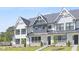 Attractive white townhouses with black-framed windows and well-maintained green lawns at 905 Myers Point Dr, Morrisville, NC 27560