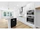 Well-equipped kitchen with modern Bosch appliances, sleek white cabinets, and a stylish island at 905 Myers Point Dr, Morrisville, NC 27560