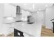 Elegant kitchen with a quartz countertop island, stainless steel appliances, and white cabinets at 905 Myers Point Dr, Morrisville, NC 27560