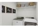 Bright laundry room featuring modern washer and dryer with wire rack and laundry-themed wall art at 905 Myers Point Dr, Morrisville, NC 27560