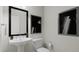 Elegant powder room featuring a pedestal sink, modern fixtures, and stylish black framed art at 905 Myers Point Dr, Morrisville, NC 27560