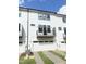Back exterior of a modern townhouse with white siding, garages, and private balconies at 905 Myers Point Dr, Morrisville, NC 27560