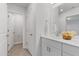 Stylish bathroom features a dual sink vanity, large mirror, and view into an adjacent room at 907 Field Ivy Dr, Fuquay Varina, NC 27526