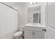 Bright bathroom with white vanity, neutral walls, and modern lighting above the mirror at 907 Field Ivy Dr, Fuquay Varina, NC 27526