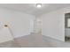 Neutral bedroom offering plush carpeting and a view into the connected laundry room at 907 Field Ivy Dr, Fuquay Varina, NC 27526