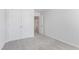Neutral bedroom featuring plush carpeting, double door closet, and light neutral paint at 907 Field Ivy Dr, Fuquay Varina, NC 27526