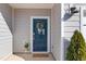 Charming home entrance with blue door and decorative wreath at 907 Field Ivy Dr, Fuquay Varina, NC 27526