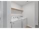 Efficient laundry room featuring a washer, dryer, and convenient shelving for storage at 907 Field Ivy Dr, Fuquay Varina, NC 27526