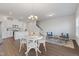 Open concept living space with modern lighting, hard floors and easy access to kitchen at 907 Field Ivy Dr, Fuquay Varina, NC 27526