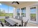 Outdoor dining area with a ceiling fan, screened porch, and a view of the backyard at 97 Willow Cameron Way, Angier, NC 27501