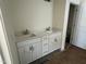 Bathroom featuring a double sink vanity with white cabinets and modern fixtures at 97 Willow Cameron Way, Angier, NC 27501