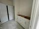 Bathroom featuring a white vanity with drawers and cabinets adjacent to walk-in closet at 97 Willow Cameron Way, Angier, NC 27501