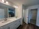 A stylish bathroom boasts double sinks, a large mirror, and access to shower and closet at 97 Willow Cameron Way, Angier, NC 27501