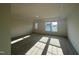 A naturally lit bedroom showcases neutral carpet, a tray ceiling, and multiple windows at 97 Willow Cameron Way, Angier, NC 27501