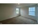 A secondary bedroom showcases two windows and neutral carpet at 97 Willow Cameron Way, Angier, NC 27501