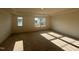 A naturally lit bedroom showcases neutral carpet, a tray ceiling, and multiple windows at 97 Willow Cameron Way, Angier, NC 27501