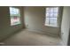 An empty bedroom with two windows provides great natural light to the space at 97 Willow Cameron Way, Angier, NC 27501