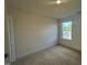 A secondary bedroom showcases a single window and neutral carpet at 97 Willow Cameron Way, Angier, NC 27501