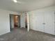 A bright bedroom showcases neutral carpet, white walls, and ensuite bathroom access at 97 Willow Cameron Way, Angier, NC 27501