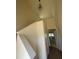 Bright entryway featuring a tall ceiling, modern light fixture and adjacent staircase at 97 Willow Cameron Way, Angier, NC 27501