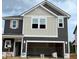 New two-story home with modern gray and white siding and an attached two-car garage at 97 Willow Cameron Way, Angier, NC 27501