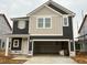 Two-story home featuring a two-car garage and a mix of vertical and horizontal siding at 97 Willow Cameron Way, Angier, NC 27501