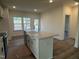 Spacious kitchen boasts a center island and a stainless steel sink and faucet at 97 Willow Cameron Way, Angier, NC 27501