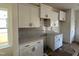 Kitchen featuring white cabinets with gray backsplash and countertops at 97 Willow Cameron Way, Angier, NC 27501
