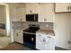 Kitchen with stainless steel appliances, white cabinets, and modern finishes at 97 Willow Cameron Way, Angier, NC 27501
