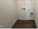 A laundry room showcases a utility sink, flooring, and washer/dryer hookups at 97 Willow Cameron Way, Angier, NC 27501