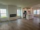 Bright open-concept layout showcases modern wood floors, large windows, fireplace, and stylish kitchen with island at 97 Willow Cameron Way, Angier, NC 27501
