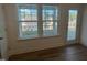 Living room features a glass door and large windows with views of the neighborhood at 97 Willow Cameron Way, Angier, NC 27501
