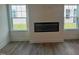 Bright living room featuring an electric fireplace and large windows with lawn views at 97 Willow Cameron Way, Angier, NC 27501