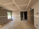 Unfinished living room with drywall walls, window, and doorway at 97 Willow Cameron Way, Angier, NC 27501