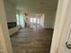 Open concept living space featuring a fireplace, modern wood flooring, and a clear view of the kitchen at 97 Willow Cameron Way, Angier, NC 27501