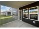 A cozy covered porch featuring square windows and sleek siding provides a welcoming transition to the indoors at 97 Willow Cameron Way, Angier, NC 27501