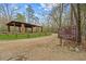 Image shows a covered recreation area with picnic tables and a sign listing nearby trail distances at 97 Willow Cameron Way, Angier, NC 27501