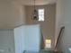 Bright stairwell featuring an ornate chandelier, windows and white trim at 97 Willow Cameron Way, Angier, NC 27501
