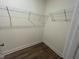 Walk-in closet with wall-mounted shelves and wood-look flooring at 97 Willow Cameron Way, Angier, NC 27501