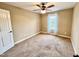 A cozy bedroom with a ceiling fan, carpeted floors, and plenty of natural light at 102 Westchase Dr, Clayton, NC 27527