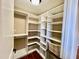 A walk-in closet featuring built-in shelves, hanging rods, and a pull out basket at 102 Westchase Dr, Clayton, NC 27527