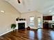 Bright living room featuring a fireplace, wood floors, and natural light at 102 Westchase Dr, Clayton, NC 27527