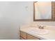 Simple bathroom with a single sink vanity and a wooden framed mirror at 1040 Sheetbend Ln, Raleigh, NC 27606