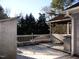 Backyard deck offering a view of the treeline and a screened in porch at 105 Lake Rd, Henderson, NC 27537